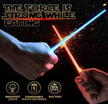 two people light saber fighting with chopsticks in red and blue