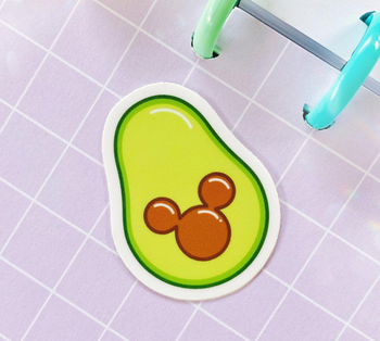an avocado sticker with a mickey pit