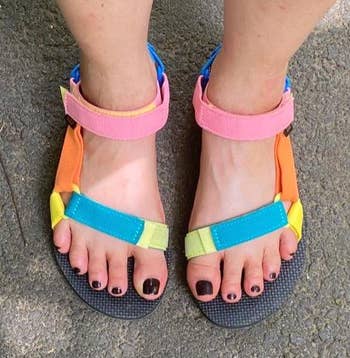 reviewer's feet in the multicolored sandals