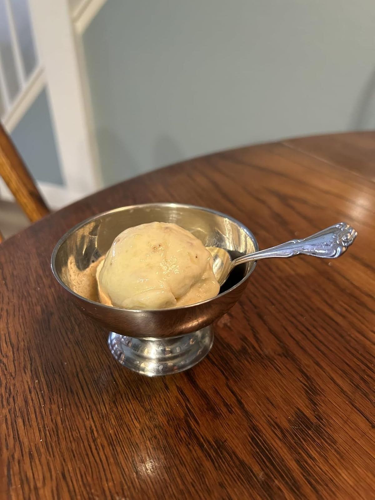 banana brushed  service  successful  a metallic  crockery  with a spoon connected  a woody  table