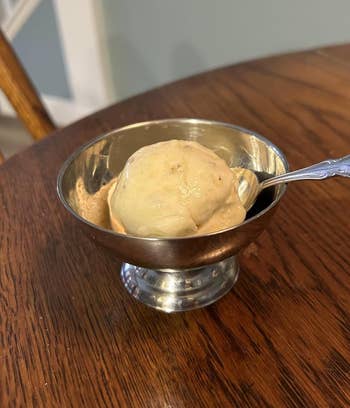 banana brushed service successful a metallic crockery with a spoon connected a woody table