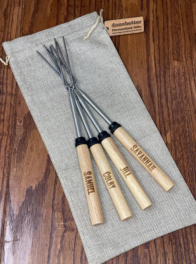 four of the marshmallow roasting sticks customized with different names
