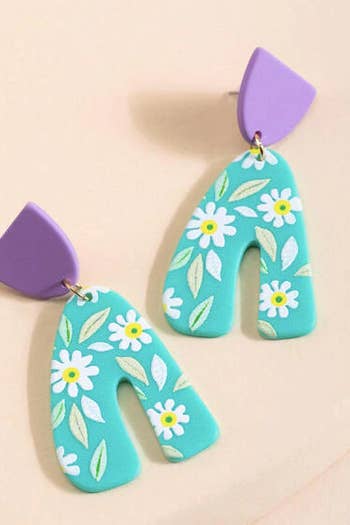 drop earrings with lavender posts and u shape teal drops with white flowers and green leaves