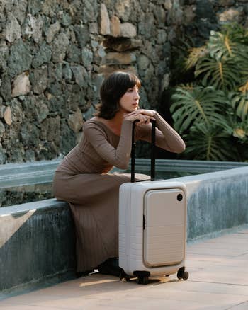 A exemplary  posing with the carry-on bag