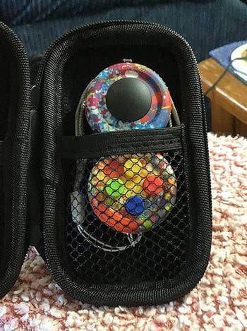 Reviewer image of the multicolored fidget toy in its black case