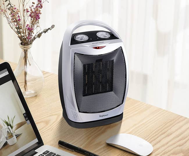 silver portable space heater on a desk