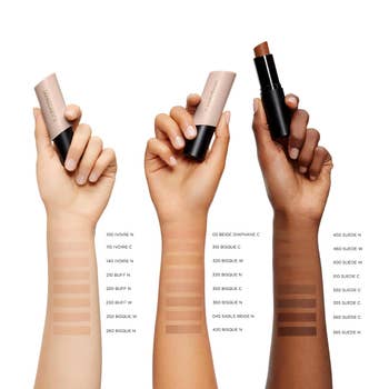 Three hands displaying instauration sticks of varying shades, each with swatch samples labeled by fig connected the skin, showcasing a constitution range