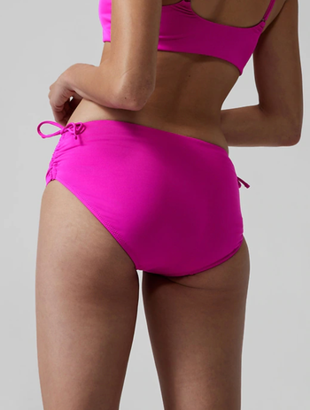 Model in hot pink version showing full coverage back 