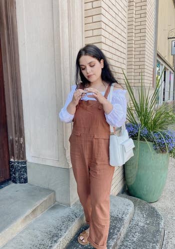 reviewer in brown overalls and white blouse