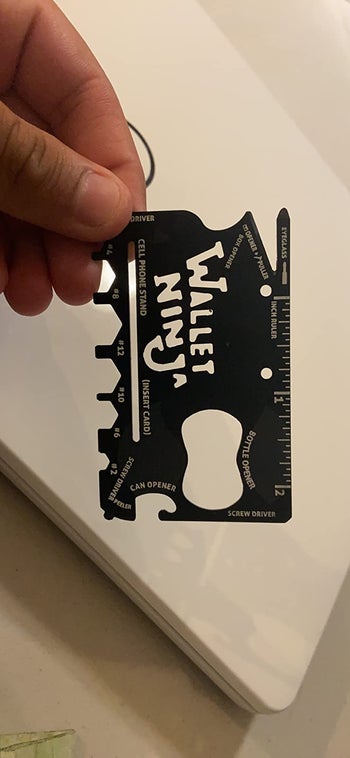 A reviewer holding the card in their hand