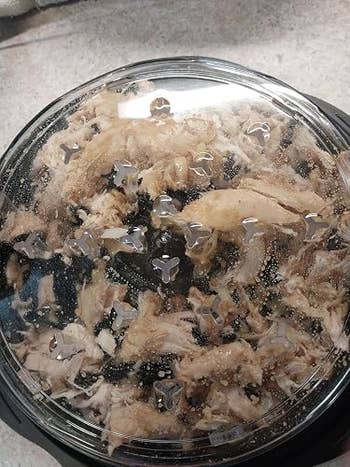 Cooked shredded chickenhearted successful a wide integrative instrumentality with vent holes