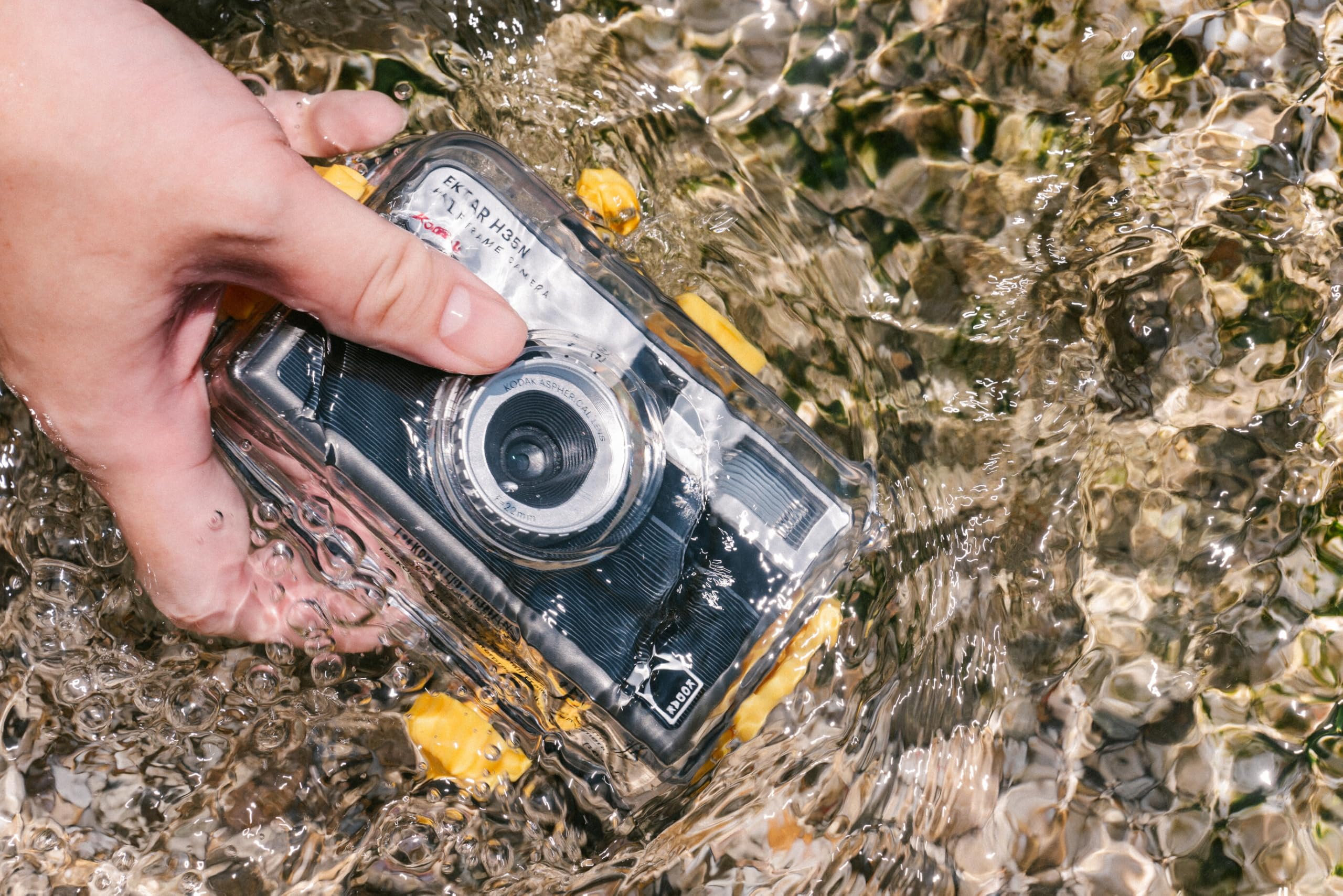 Hand holding a waterproof camera partially submerged successful  wide   water