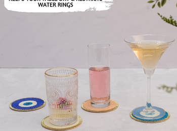 the set of four coasters with drinks on top of them