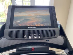 reviewer photo of treadmill screen showing skyscape