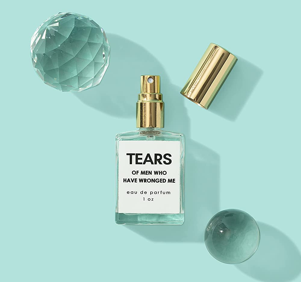 the clear and gold perfume bottle with minimal label with text