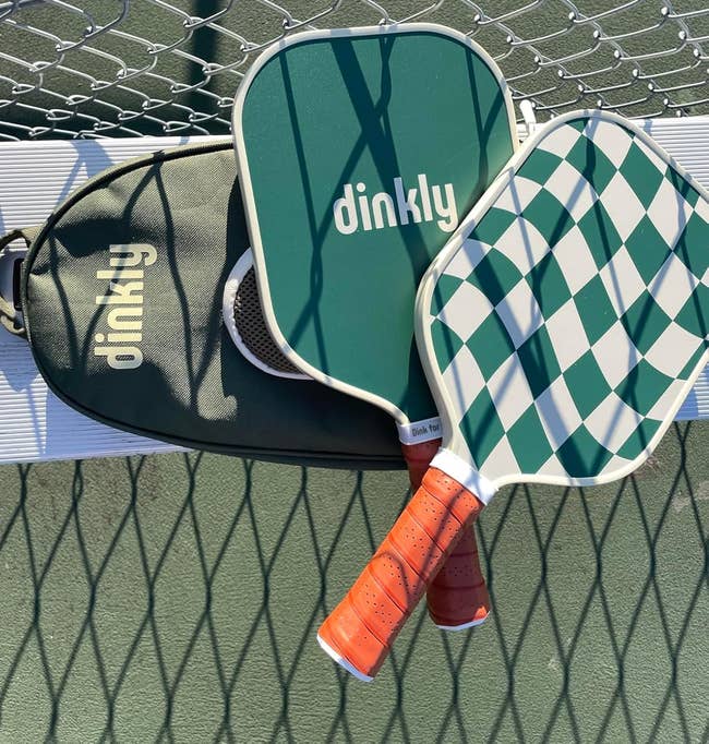 Two pickleball paddles, one solid and one with a checkered pattern