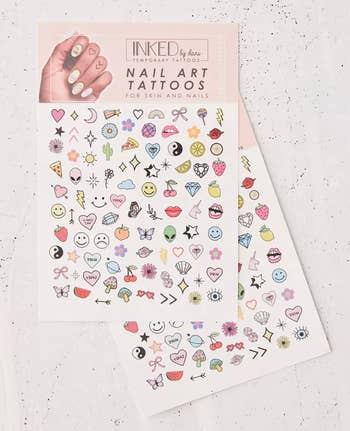 Tattoo sheet with lots of tiny temporary tattoos of flowers, hearts, fruits, and other cute things 