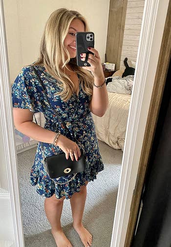 reviewer in a blue floral dress