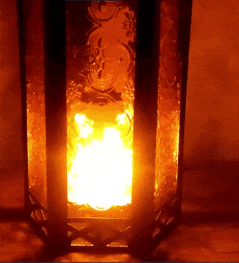 gif of the lantern glowing at night with a candle lit inside