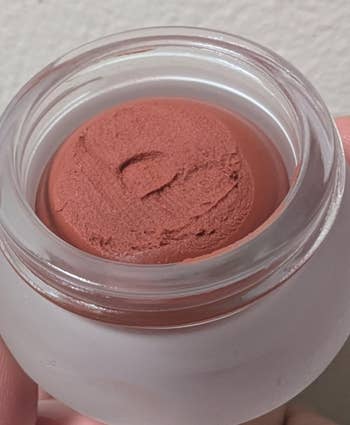 Cosmetic pick  successful  a wide   container, showcasing its creaseless  texture. Ideal for quality   and skincare buying  content