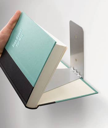 showing the book how it fits onto the book shelf bracket