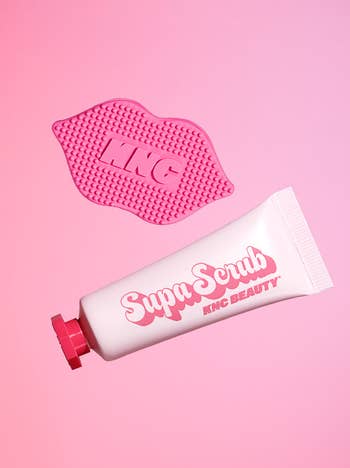 Supa Scrub tube and exfoliating pad by KNC Beauty on a pink background