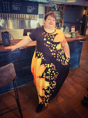 Person wearing a bold, patterned formal stands successful a barroom country with manus resting connected counter