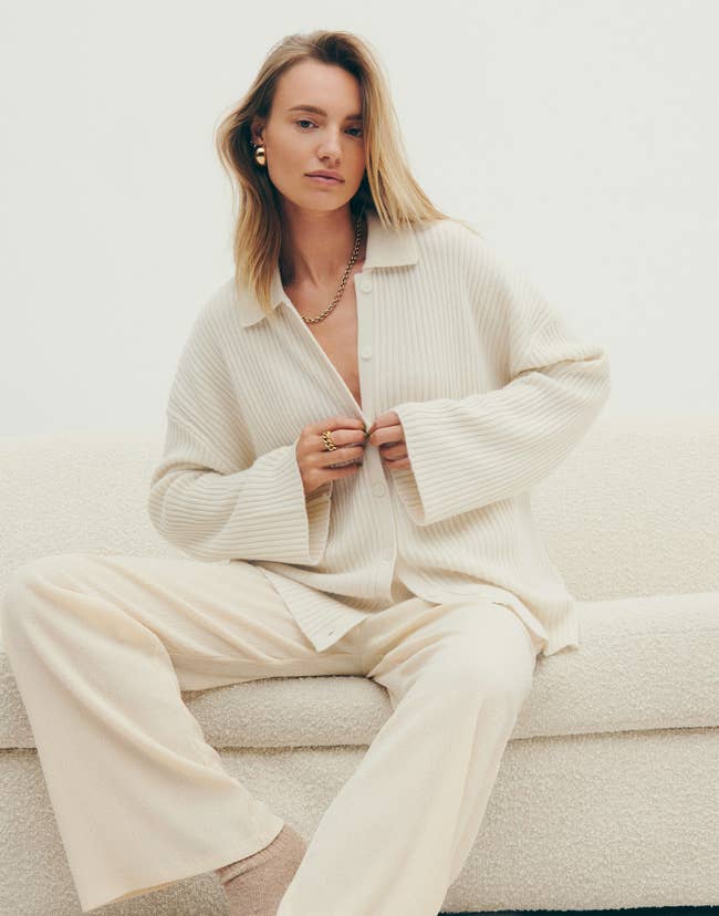 A model posing in the ivory sweater