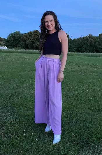 reviewer wearing the lavender pants with a black tank