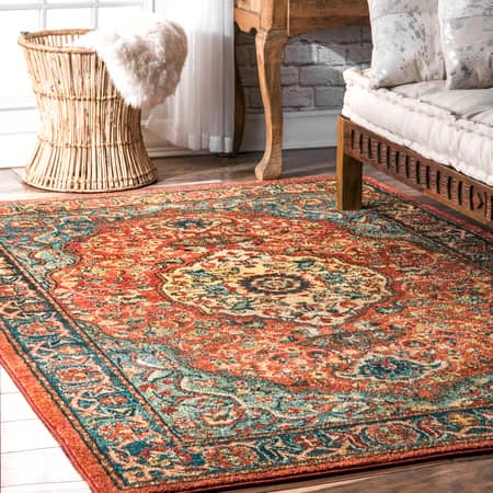 the burnt orange area rug which has a floral medallion pattern