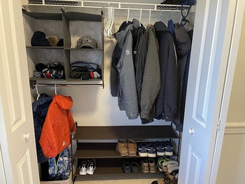 reviewer photo of organized closet with the organizer in the corner