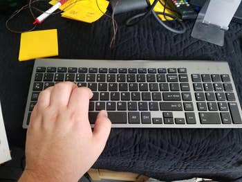 Reviewer's hand on wireless keyboard
