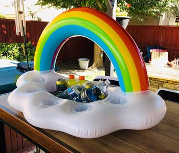 reviewer using rainbow float to hold drinks