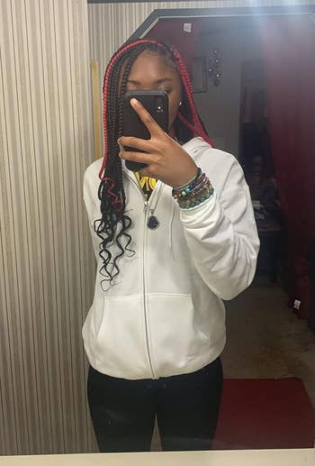 reviewer wearing a white hoodie