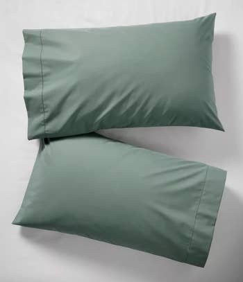 Two neatly arranged pillowcases on a bed, showcasing smooth fabric texture