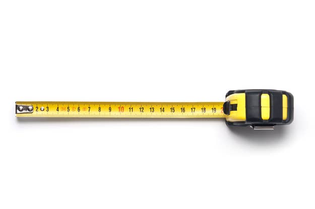 A tape measure fully extended on a white background, showing measurements in both inches and centimeters