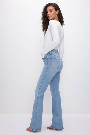 model showing a side view of the light denim jeans