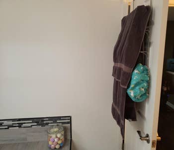 reviewer pic of the same towels on a wall mounted towel rack