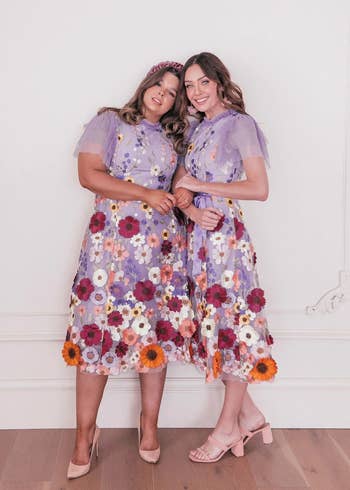 two models in the lilac floral dress