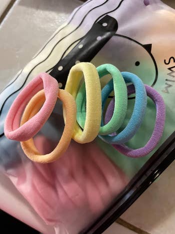 another reviewer's pack of hair ties in an assortment of rainbow colors