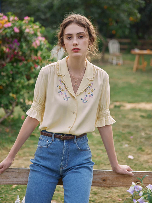 a model wearing the blouse in yellow