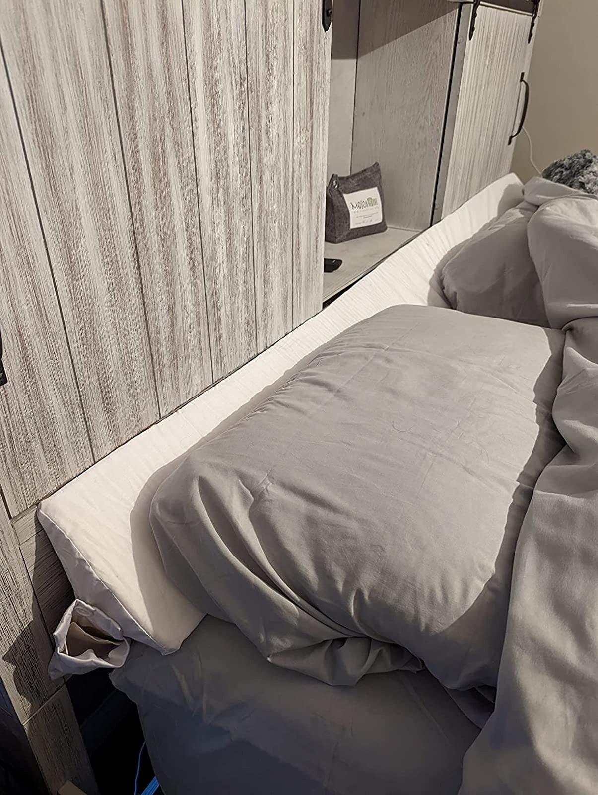 reviewer image of the wedge gap pillow on a bed
