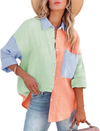 A model in a patchwork button-up shirt with blue, green, and orange sections