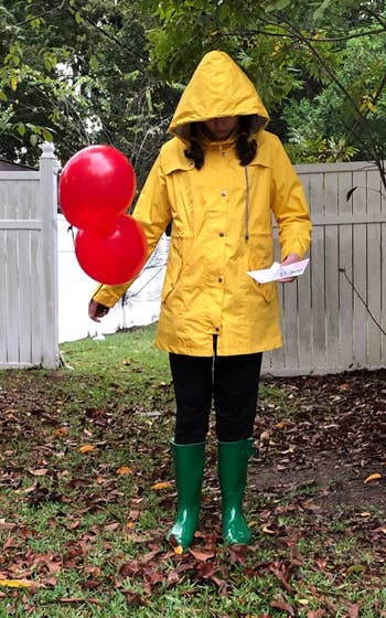 reviewer wearing a yellow rain jacket with hood up