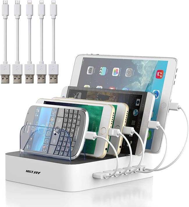 The white organizer with clear dividers and five devices plugged in