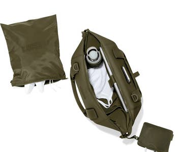 a top-down view of the landon carryall filled with a laptop, water bottle, and some clothes sitting next to an attached mesh pouch and a shoe bag 