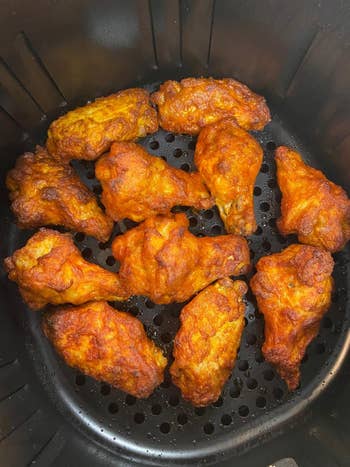 Freshly cooked chicken wings in an air fryer, ready for serving or adding to a meal