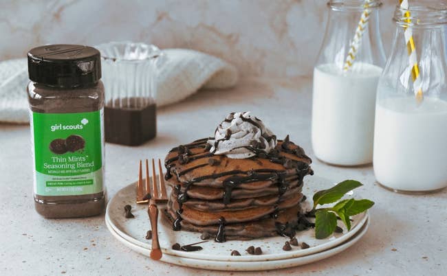 image of the jar of seasoning next to a plate of chocolate chip pancakes