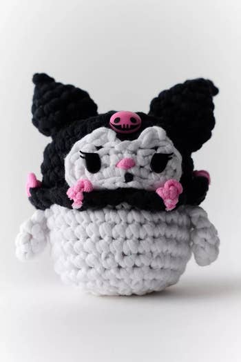 Crocheted quality  doll with achromatic  horned chapeau  and pinkish  decorations, featured for buying  article