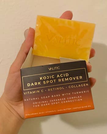 reviewer holding packaging and soap bar